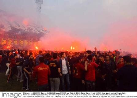 Feb. 1, 2016 - Cairo, Cairo, Egypt - Al Ahly fans, also known as Ultras , light flares and shout slogans at al-Ahly club s training stadium marking the fourt anniversary of killing al-Ahly fans in what known as the Port Said massacre , on February 1, 2016. On 1 February 2012, a massive riot occurred at Port Said Stadium in Port Said city, Egypt, following an Egyptian Premier League football match between El Masry and El Ahly clubs. At least 74 people were killed and more than 500 were injured after thousands of El Masry spectators stormed the stadium stands and the pitch Cairo Egypt - ZUMAap3_