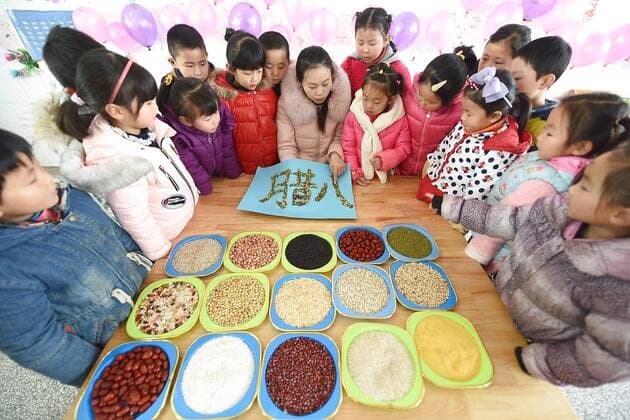 January 4, 2017 - Lianyungang, Lianyungang, China - Lianyungang, CHINA-January 4 2017: (EDITORIAL USE ONLY. CHINA OUT)..Pupils learn to recognize five kinds of cereals under the guidance of teacher at a primary school in Donghai County, Lianyungang City,east China s Jiangsu Province, January 4th, 2017, celebrating the Laba Rice Porridge Festival which falls on January 5th this year. The Laba Rice Porridge Festival is a traditional Chinese festival falls on the 8th day of the 12th month of lunar calendar. It s customary on this day to drink the special porridge, usually stewed of at least eight ingredients. With rice as the main ingredient, this porridge may well contain ingredients like broad beans, red beans, mung beans, red dates, peanuts, chest nuts, both tasty and nutritious. Lianyungang China - ZUMAs145 20170104_zaa_s145_189