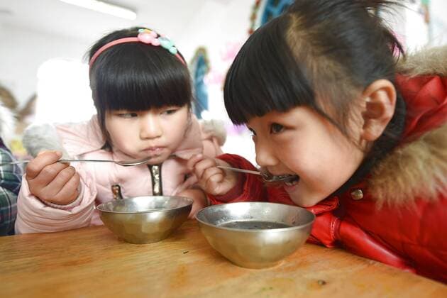 January 4, 2017 - Lianyungang, Lianyungang, China - Lianyungang, CHINA-January 4 2017: (EDITORIAL USE ONLY. CHINA OUT)..Pupils enjoy the Laba rice porridge at a primary school in Donghai County, Lianyungang City,east China s Jiangsu Province, January 4th, 2017, celebrating the Laba Rice Porridge Festival which falls on January 5th this year. The Laba Rice Porridge Festival is a traditional Chinese festival falls on the 8th day of the 12th month of lunar calendar. It s customary on this day to drink the special porridge, usually stewed of at least eight ingredients. With rice as the main ingredient, this porridge may well contain ingredients like broad beans, red beans, mung beans, red dates, peanuts, chest nuts, both tasty and nutritious. Lianyungang China - ZUMAs145 20170104_zaa_s145_194