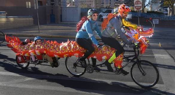 October 29, 2017 - U.S. - ASEC -- An online order of a dragon from China was adapted for a costume on the bike and trailer attachment for Prevost family of Albuquerque, Amelia, 2, Ayrton, 4, Merideth and Guy, from left, during the Day of the Tread bike ride at the Civic Plaza on Sunday, October 29, 2017. They were starting on the 26 mile event. The charity bike ride benefits the Pegaus Legal Services for Children, Zia Freewheelers Adaptive Cycling and Zia Freewheelers Adaptive Cycling and Esperanza Bike Shop. U.S. - ZUMAab1_ 20171029_zaf_ab1_006 Copyright: xGregxSorberx