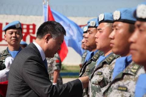(180406) -- BEIRUT, April 6, 2018 -- Chinese Ambassador to Lebanon Wang Kejian (L, Front) awards Chinese peacekeepers the United Nations Peace Medal of Honor at the awarding ceremony at the camp of the Chinese peacekeeping multi-functional engineer detachment to Lebanon in Hanniyah village in southern Lebanon, on April 6, 2018. The 410 members of the 16th Chinese peacekeeping force to Lebanon were awarded the United Nations Peace Medal of Honor on Friday, a month before their transfer of authority to the 17th contingent. ) LEBANON-HANNIYAH VILLAGE-CHINESE PEACEKEEPERS-UN PEACE MEDAL OF HONOR-AWARDING LixLiangyong