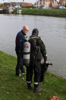 - BRUGGE, BELGIUM: Illustration picture shows divers and a boat searching for Frederic Coopman, Tuesday 13 December 2011 in the Ringvaart river in Brugge. 20 year old student Coopman has been missing since he left a party on Saturday, his gray woolen hat and one of his black gloves were found at the Gentpoort in Brugge. KURTxDESPLENTER x31603992x
