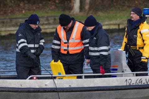 - BRUGGE, BELGIUM: Illustration picture shows divers and police during the search for Frederic Coopman, Tuesday 13 December 2011 in the Ringvaart river in Brugge. 20 year old student Coopman has been missing since he left a party on Saturday, his gray woolen hat and one of his black gloves were found at the Gentpoort in Brugge. KURTxDESPLENTER x31604189x
