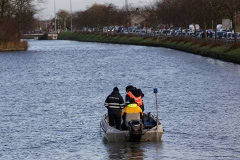 - BRUGGE, BELGIUM: Illustration picture shows divers and police during the search for Frederic Coopman, Tuesday 13 December 2011 in the Ringvaart river in Brugge. 20 year old student Coopman has been missing since he left a party on Saturday, his gray woolen hat and one of his black gloves were found at the Gentpoort in Brugge. KURTxDESPLENTER x31604212x
