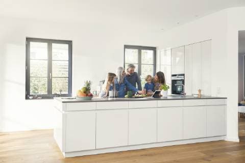 Happy family with grandparents and children standing in the kitchen model released Symbolfoto property released SBOF00508