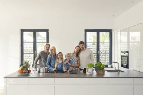 Happy family with grandparents and children standing in the kitchen model released Symbolfoto property released SBOF00509