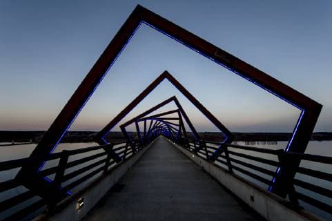 March 22, 2019 - Madrid, Iowa, U.S. - Originally a conduit for rail freight, but now a decomissioned railroad line, the High Trestle Trail Bridge is part of the 25-mile Trestle Trail path for bikers, hikers and horseback riders. The artistic, spiral steel frames springing up from the road bed are a nod to the shape of the timbers placed in former central Iowa coal mines. Madrid U.S. - ZUMAce6_ 20190322_zaf_ce6_017 Copyright: xBrianxCahnx