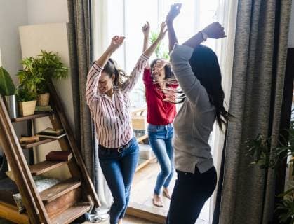 Three women at home having a party and dancing model released Symbolfoto property released GIOF05551