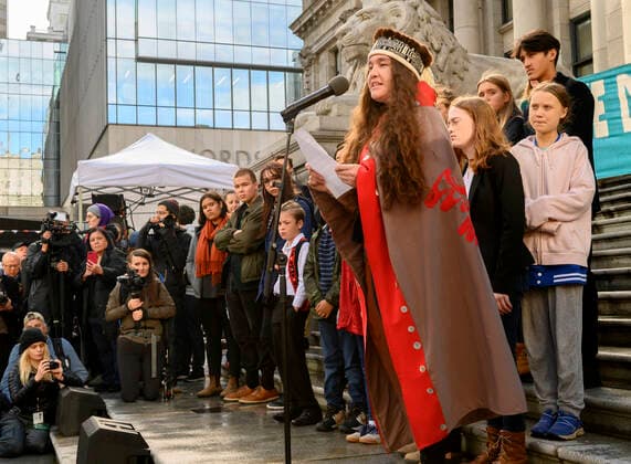 October 25, 2019, Vancouver, BRITISH COLUMBIA, CANADA: Youth climate activist HANNA EDENSHAW of Haida Gwaii, British Columbia, speaks during a rally in downtown Vancouver on Friday. Behind her, in pink, is Swedish climate activist GRETA THUNBERG. Enenshaw is one of 15 plaintiffs, ages 7-19, who launched a lawsuit today against the Canadian government for their personal injuries as a direct result of the climate change. Vancouver CANADA - ZUMAl31_ 20191025_zaf_l31_008 Copyright: xRobinxLoznakx