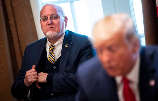 March 18, 2020, Washington, District of Columbia, USA: Director of the Centers for Disease Control and Prevention Dr. Robert Redfield, left, listens as United States President Donald J. Trump speaks to reporters as he holds a meeting with nurses on the COVID-19 response at the White House in Washington, DC, March 18, 2020, in Washington, D.C. .Credit: Pool via CNP Washington USA - ZUMAs152 20200318_zaa_s152_062 Copyright: xKevinxDietschx