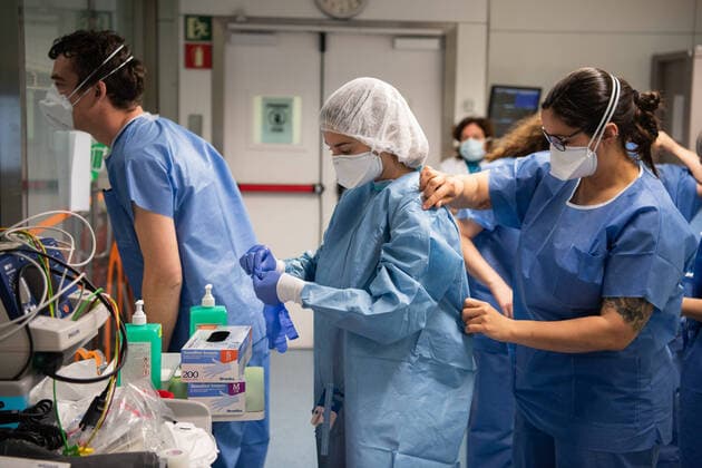 (200320) -- BARCELONA, March 20, 2020 (Xinhua) -- Medical workers put on protective suits at a hospital in Barcelona, Spain, March 20, 2020. Spain has reported over 1,000 deaths of COVID-19, the disease caused by the novel coronavirus, the Spanish Ministry for Health, Consumer Affairs and Social Services confirmed on Friday. According to the ministry, 1,002 people have now lost their lives from COVID-19, in comparison with the 767 deaths a day ago. (Photo by Francisco Avia Xinhua) SPAIN-BARCELONA-COVID-19-HOSPITAL