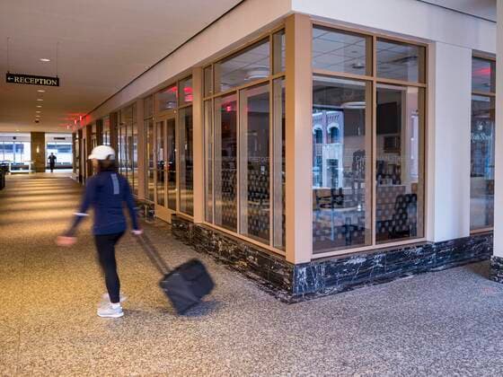 March 20, 2020, Des Moines, Iowa, U.S: A person walks through the lobby of 801 Grand, the tallest office tower in Iowa, Friday morning. The building is a part of the campus of Principal, a large financial services company. The building was shutdown Friday after a visitor tested positive for COVID-19. Some workers were placed in self quarantine and all were ordered to work from home. On Friday morning, 20 March, Iowa reported 45 confirmed cases of the Coronavirus. Restaurants, bars, movie theaters, places that draw crowds are closed for at least 30 days. There are no shelter in place orders in effect anywhere in Iowa but people are being encouraged to practice social distancing and many businesses are requiring or encouraging employees to telecommute. Des Moines U.S. - ZUMAk94_ 20200320_zaf_k94_001 Copyright: xJackxKurtzx