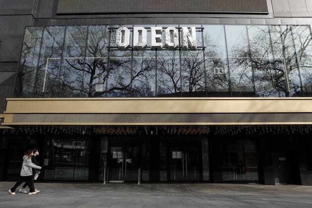 (200321) -- LONDON, March 21, 2020 (Xinhua) -- People walk past a closed cinema in Leicester Square, central London, Britain, on March 21, 2020. As of 9a.m. (0900GMT) on Saturday, 72,818 people have been tested in Britain, of which 67,800 were confirmed negative and 5,018 were confirmed positive. 233 patients in the country who tested positive for the virus have died. (Photo by Tim Ireland Xinhua) BRITAIN-LONDON-COVID-19