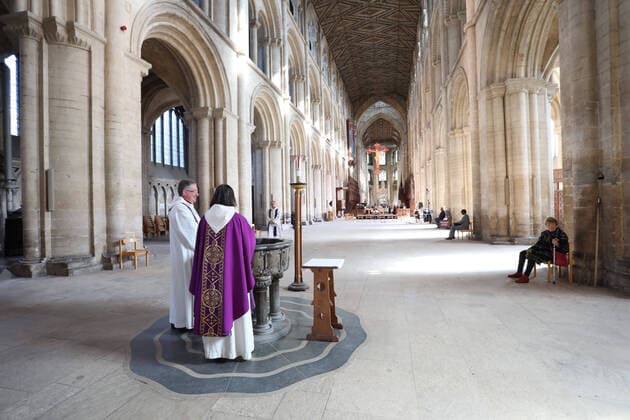 The Mothering Sunday service at Peterborough Cathedral goes ahead without a congregation as it is live streamed across the internet for people to watch wherever they can. The COVID-19 Coronavirus pandemic crisis continues, with cafes, bars, restaurants, gyms and leisure centres forced to close, as well as places of worship like churches, cathedrals, mosques and synagogues. COVID-19 Coronavirus crisis, Peterborough, Cambridgeshire, UK, on March 22, 2020