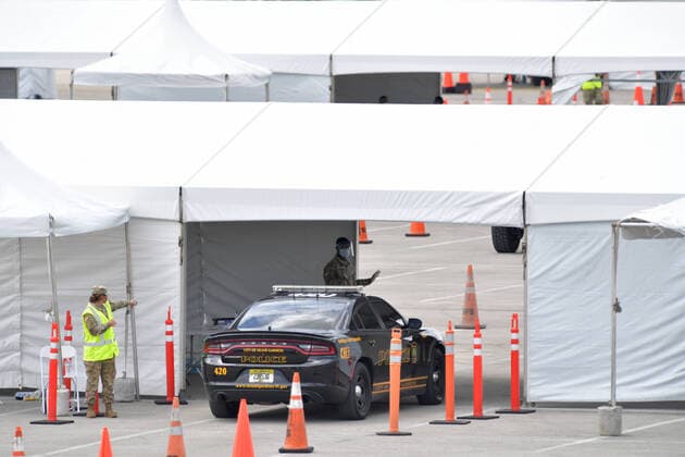 March 23, 2020, Miami Gardens, Florida, United States Of America: MIAMI GARDENS, FL - MARCH 22: FIRST RESPONDERS ONLY TESTING DAY - Instead of setting up for the Miami Open tennis tournament, the Florida National Guard (many without face masks due to shortage) was running a drive-through testing site off the Florida Turnpike at the Hard Rock Stadium in Miami Gardens where people can go for a COVID-19 Test Without Getting out of their Cars. As Miami-Dade Countys number of COVID-19 cases rise to 169, the site will open at 9 a.m. Monday in the east parking lot of the Hard Rock Stadium, 347 Don Shula Drive. The testing is free and the site will be open from 9 a.m. to 5 p.m. on a daily basis, said Juan Diasgranados, a spokesperson for the testing site. The test site will be run and was created by several local, state and national agencies wh - ZUMAs214 20200323_zaa_s214_024 Copyright: xSMGx