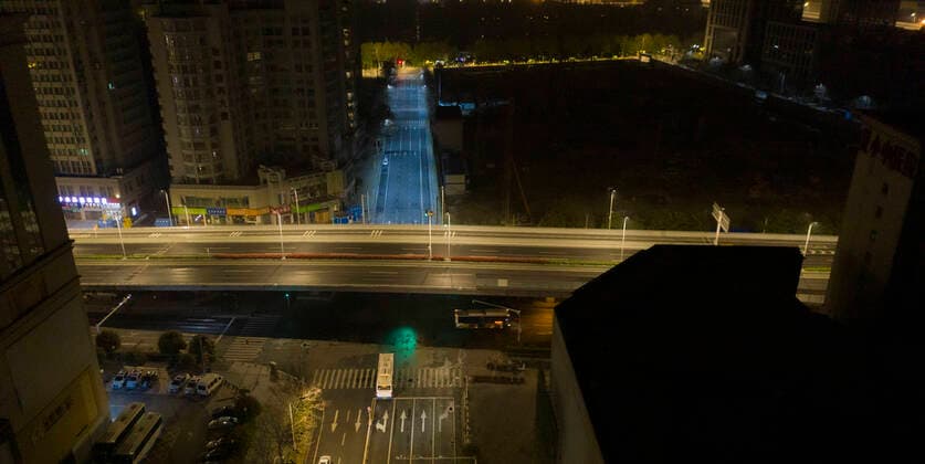 (200325) -- WUHAN, March 25, 2020 -- Photo taken on March 25, 2020 shows an early bus running on a road in Wuhan, central China s Hubei Province. Wuhan, the once hardest-hit city in central China s Hubei Province during the COVID-19 outbreak, resumed a total of 117 bus routes starting Wednesday, around 30 percent of the city s total bus transport capacity, the municipal transport bureau said. According to a spokesperson of the bureau, passengers must wear masks, register with their names and scan a QR code, and take a temperature check before taking buses and subways. ) CHINA-HUBEI-WUHAN-COVID-19-BUS ROUTES-RESUMPTION (CN) CaixYang