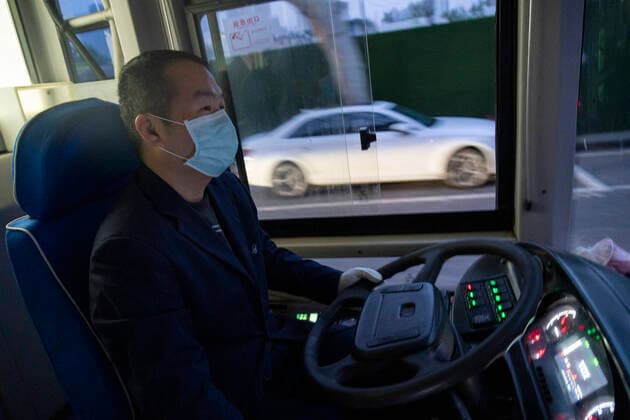 (200325) -- WUHAN, March 25, 2020 -- A driver drives a bus in Wuhan, central China s Hubei Province, March 25, 2020. Wuhan, the once hardest-hit city in central China s Hubei Province during the COVID-19 outbreak, resumed a total of 117 bus routes starting Wednesday, around 30 percent of the city s total bus transport capacity, the municipal transport bureau said. According to a spokesperson of the bureau, passengers must wear masks, register with their names and scan a QR code, and take a temperature check before taking buses and subways. ) CHINA-HUBEI-WUHAN-COVID-19-BUS ROUTES-RESUMPTION (CN) CaixYang