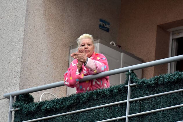 April 2, 2020, El Vendrell, Spain: A woman applauds from the terrace of her house to show gratitude to the Covid-19 fighters..In Spain, every night at 08:00 pm and all the cities of the country, citizens who are confined at home during the state of alarm decreed by the Government of Spain since March 16, go out to their terraces and applaud to show gratitude to all the people such as health workers, police, fire fighters, supermarket staff, truckers, and cleaning staff for their great work in fighting the Covid-19 crisis. El Vendrell Spain - ZUMAs197 20200402_zaa_s197_075 Copyright: xRamonxCostax