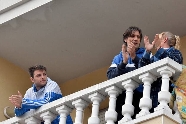 April 2, 2020, El Vendrell, Spain: A family applaud from the terrace of their house to show gratitude to the Covid-19 fighters..In Spain, every night at 08:00 pm and all the cities of the country, citizens who are confined at home during the state of alarm decreed by the Government of Spain since March 16, go out to their terraces and applaud to show gratitude to all the people such as health workers, police, fire fighters, supermarket staff, truckers, and cleaning staff for their great work in fighting the Covid-19 crisis. El Vendrell Spain - ZUMAs197 20200402_zaa_s197_076 Copyright: xRamonxCostax