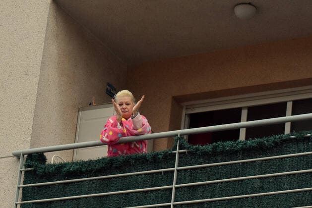 April 2, 2020, El Vendrell, Spain: A woman applauds from the terrace of her house to show gratitude to the Covid-19 fighters..In Spain, every night at 08:00 pm and all the cities of the country, citizens who are confined at home during the state of alarm decreed by the Government of Spain since March 16, go out to their terraces and applaud to show gratitude to all the people such as health workers, police, fire fighters, supermarket staff, truckers, and cleaning staff for their great work in fighting the Covid-19 crisis. El Vendrell Spain - ZUMAs197 20200402_zaa_s197_077 Copyright: xRamonxCostax