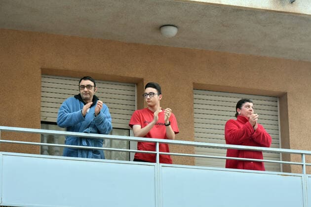 April 2, 2020, El Vendrell, Spain: A family applaud from the terrace of their house to show gratitude to the Covid-19 fighters..In Spain, every night at 08:00 pm and all the cities of the country, citizens who are confined at home during the state of alarm decreed by the Government of Spain since March 16, go out to their terraces and applaud to show gratitude to all the people such as health workers, police, fire fighters, supermarket staff, truckers, and cleaning staff for their great work in fighting the Covid-19 crisis. El Vendrell Spain - ZUMAs197 20200402_zaa_s197_079 Copyright: xRamonxCostax
