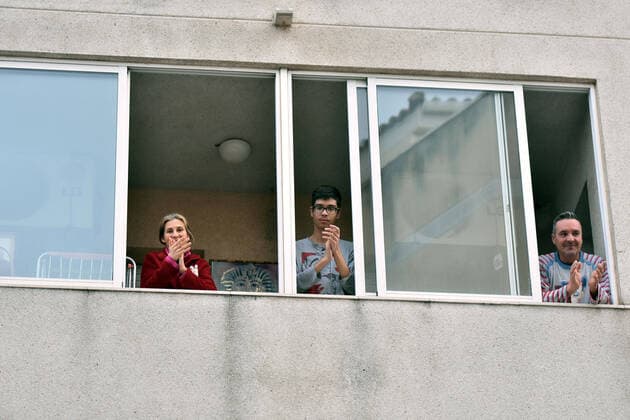 April 2, 2020, El Vendrell, Spain: A family applaud from the terrace of their house to show gratitude to the Covid-19 fighters..In Spain, every night at 08:00 pm and all the cities of the country, citizens who are confined at home during the state of alarm decreed by the Government of Spain since March 16, go out to their terraces and applaud to show gratitude to all the people such as health workers, police, fire fighters, supermarket staff, truckers, and cleaning staff for their great work in fighting the Covid-19 crisis. El Vendrell Spain - ZUMAs197 20200402_zaa_s197_081 Copyright: xRamonxCostax