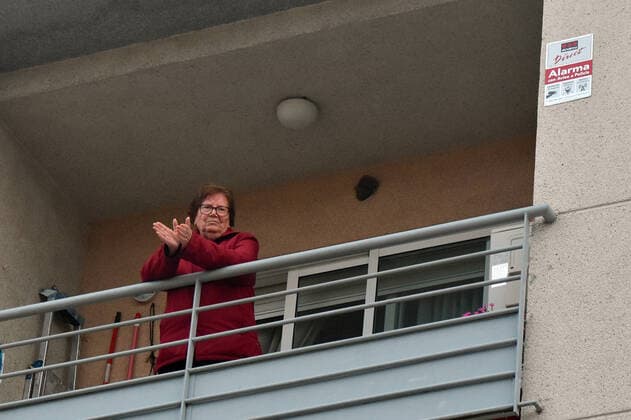 April 2, 2020, El Vendrell, Spain: A woman applauds from the terrace of her house to show gratitude to the Covid-19 fighters..In Spain, every night at 08:00 pm and all the cities of the country, citizens who are confined at home during the state of alarm decreed by the Government of Spain since March 16, go out to their terraces and applaud to show gratitude to all the people such as health workers, police, fire fighters, supermarket staff, truckers, and cleaning staff for their great work in fighting the Covid-19 crisis. El Vendrell Spain - ZUMAs197 20200402_zaa_s197_082 Copyright: xRamonxCostax