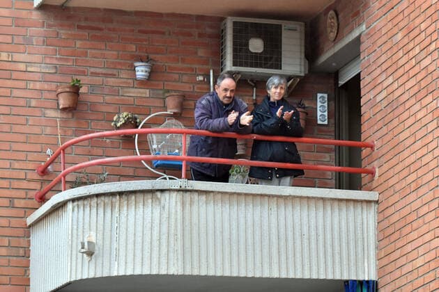 April 2, 2020, El Vendrell, Spain: A couple applaud from the terrace of their house to show gratitude to the Covid-19 fighters..In Spain, every night at 08:00 pm and all the cities of the country, citizens who are confined at home during the state of alarm decreed by the Government of Spain since March 16, go out to their terraces and applaud to show gratitude to all the people such as health workers, police, fire fighters, supermarket staff, truckers, and cleaning staff for their great work in fighting the Covid-19 crisis. El Vendrell Spain - ZUMAs197 20200402_zaa_s197_084 Copyright: xRamonxCostax