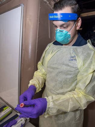 March 31, 2020, Washington, The District of Columbia, United States Of America: APRA HARBOR, Guam (April 1, 2020) Hospital Corpsman 2nd Class Jason Castircone, from Dallas, wraps a swab sample in parafilm for COVID-19 testing aboard the aircraft carrier USS Theodore Roosevelt (CVN 71), April 1, 2020. Theodore Roosevelt is in Guam for a scheduled port visit for resupply and crew rest during their scheduled deployment to the Indo-Pacificring their scheduled deployment to the Indo-Pacific...People: USS Theodore Roosevelt. Washington United States Of America - ZUMAs214 20200331_zaa_s214_003 Copyright: xSMGx