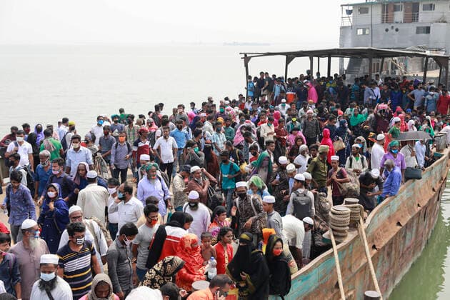 April 5, 2020, Mawa, Dhaka, Bangladesh: Thousands of readymade garment workers from across the country had either walked or used alternative modes of transpiration to reach capital Dhaka over the past few days, as owners decided to open the factories amid a government-enforced soft shutdown to prevent the novel coronavirus from spreading further. But following harsh criticisms, BGMEA was forced to keep the factories closed until April 11. The workers were told to go back home when they went to the factories to join work on Sunday morning. These photoss of people returning to their village homes were taken at the Shimulia ferry terminal in Mawa, near Dhaka, Bangladesh, April 05, 2020. Mawa Bangladesh - ZUMAd117 20200405_zap_d117_005 Copyright: xSuvraxKantixDasx