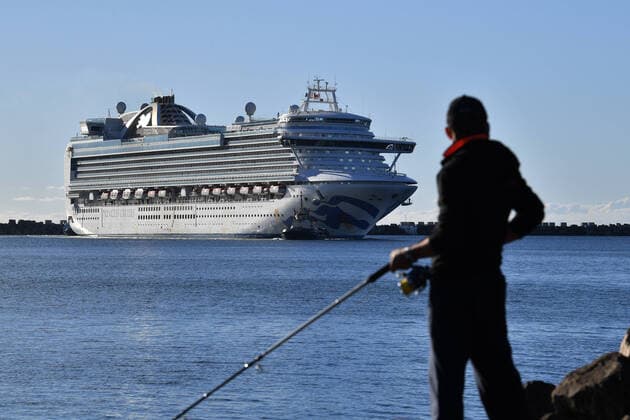 RUBY PRINCESS COVID-19 EVACUATIONS, A fisherman wearing a face mask looks on as the Ruby Princess, with crew only onboard, docks at Port Kembla, Wollongong, Monday, April 6, 2020. A criminal investigation will be launched into how cruise line operator Carnival Australia was allowed to disembark Ruby Princess passengers in Sydney, resulting in several deaths and COVID-19 outbreaks throughout the country. ( NO ARCHIVING, EDITORIAL USE ONLY, NO USE IN BOOKS WITHOUT CONSENT SYDNEY NSW AUSTRALIA Copyright: xDEANxLEWINSx 20200406001461955402