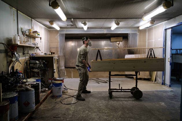April 8, 2020, Barcelona, Spain: A worker paints a coffin in the largest coffin factory in Catalonia...Coronavirus outbreak in Spain has already killed 14,659 people. The large number of deaths has forced Eurocoffin, the main coffin factory in Catalonia, to triple its production, from 50 to 150 coffins per day. Isolation and quarantine prevent family members from gettting infected or infect others. In Spain today, the pandemic leaves numbers of 146,690 infected and 48,021 recovered. Barcelona Spain - ZUMAs197 20200408_zaa_s197_154 Copyright: xPabloxMiranzox