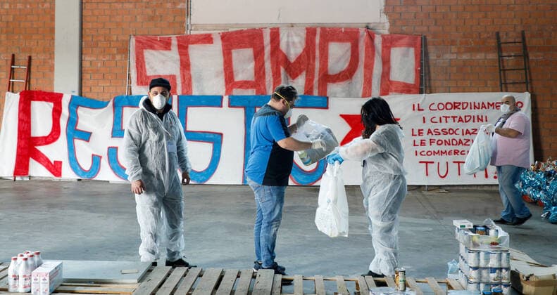 April 11, 2020, Naples, Campania, Italy: Italy, 11 04 2020, Naples, Scampia district, a group of associations from the northern area of the Neapolitan city with their volunteers, to face the poverty of families in the period of the quarantine for the pandemic for the covid-19 virus, go around the houses delivering basic necessities for Easter. Naples Italy - ZUMAs236 20200411_zap_s236_024 Copyright: xFabioxSassox