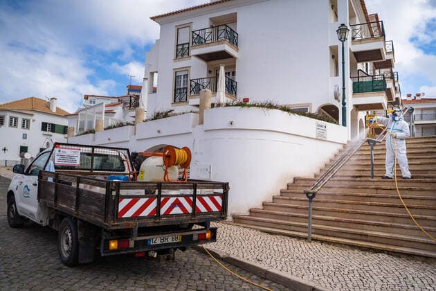 April 14, 2020, Ericeira, Portugal: An employee of the Ericeira parish council, equipped with the recommended protective materials, disinfects the street with a solution based on hypochlorite (bleach)..The municipality of Mafra had 70 cases of COVID-19 pandemic. In order to prevent the spread of the virus, the Ericeira Parish Council perform weekly street disinfection. Ericeira Portugal - ZUMAs197 20200414_zaa_s197_173 Copyright: xHenriquexCasinhasx