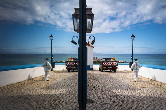 April 14, 2020, Ericeira, Portugal: An employee of the Ericeira parish council, equipped with the recommended protective materials, disinfects the street with a solution based on hypochlorite (bleach)..The municipality of Mafra had 70 cases of COVID-19 pandemic. In order to prevent the spread of the virus, the Ericeira Parish Council perform weekly street disinfection. Ericeira Portugal - ZUMAs197 20200414_zaa_s197_185 Copyright: xHenriquexCasinhasx