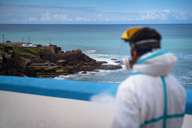 April 14, 2020, Ericeira, Portugal: An employee of the Ericeira parish council, equipped with the recommended protective materials, disinfects the street with a solution based on hypochlorite (bleach)..The municipality of Mafra had 70 cases of COVID-19 pandemic. In order to prevent the spread of the virus, the Ericeira Parish Council perform weekly street disinfection. Ericeira Portugal - ZUMAs197 20200414_zaa_s197_187 Copyright: xHenriquexCasinhasx