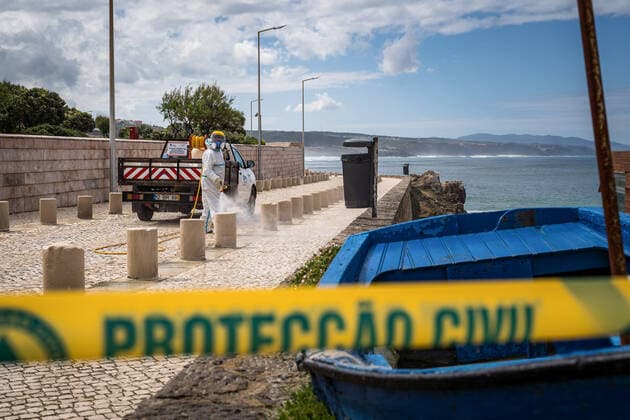 April 14, 2020, Ericeira, Portugal: An employee of the Ericeira parish council, equipped with the recommended protective materials, disinfects the street with a solution based on hypochlorite (bleach)..The municipality of Mafra had 70 cases of COVID-19 pandemic. In order to prevent the spread of the virus, the Ericeira Parish Council perform weekly street disinfection. Ericeira Portugal - ZUMAs197 20200414_zaa_s197_188 Copyright: xHenriquexCasinhasx