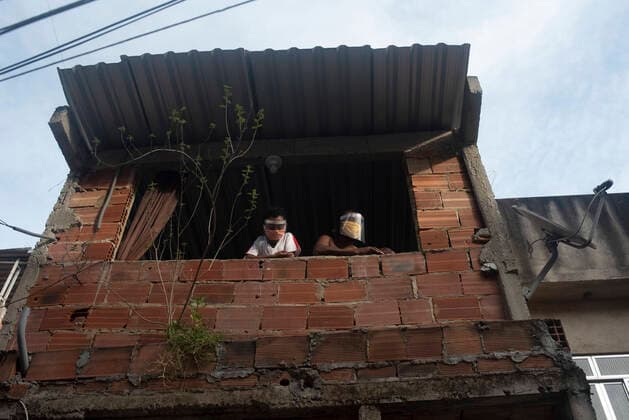 May 6, 2020, Rio De Janeiro, Rio de Janeiro, Brazil: May 08.., 2020, Rio De Janeiro, May 08.., 2020, Rio De Janeiro - Alves 40 years old, lives in the 5 Bocas favela taking care of his 8-year-old son Samuel, he is survivor from the Corona Virus Covid 19, he was infected and stayed in the hospital for 10 days, every day they wear his mask and face shield. protection, so as not to contaminate your son Samuel. Rio De Janeiro Brazil - ZUMAt142 20200506_zap_t142_003 Copyright: xFabioxTeixeirax