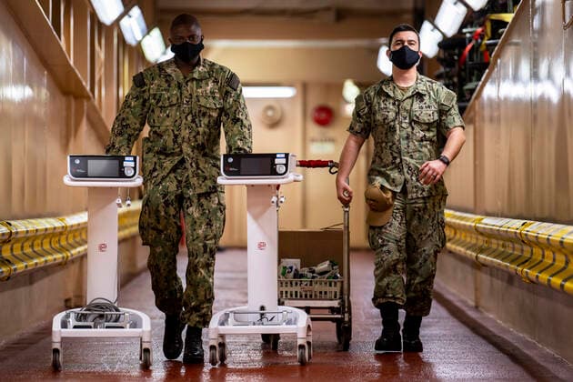 May 12, 2020 - San Diego, California, USA - Hospital Corpsman 1st Class Torrean Clarke, from Neptune City, N.J., and Hospital Corpsman 3rd Class Brandon Chorny, from Homeland, Calif., transport medical equipment aboard the hospital ship USNS Mercy (T-AH 19). Mercy deployed in support of the nation s COVID-19 response efforts, and serves as a referral hospital for non-COVID-19 patients currently admitted to shore-based hospitals. This allows shore base hospitals to focus their efforts on COVID-19 cases. One of the Department of Defense s missions is Defense Support of Civil Authorities. DoD is supporting the Federal Emergency Management Agency, the lead federal agency, as well as state, local and public health authorities in helping protect the health and safety of the American people. San Diego USA - ZUMAz03_ 20200512_sha_z03_904 Copyright: xU.S.xNavyx