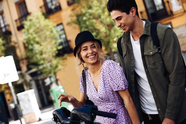 Young cheerful couple in casual clothes having fun during dating outdoors, Model released Copyright: xRamonxLopezx MR