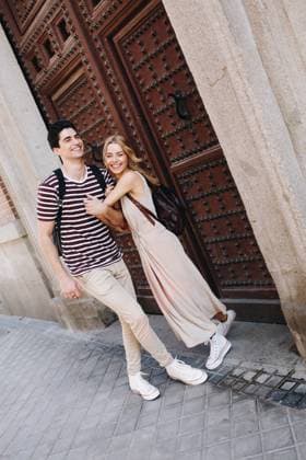 Young cheerful couple in casual clothes having fun during dating outdoors, Model released Copyright: xRamonxLopezx MR