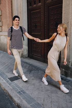 Young cheerful couple in casual clothes having fun during dating outdoors, Model released Copyright: xRamonxLopezx MR