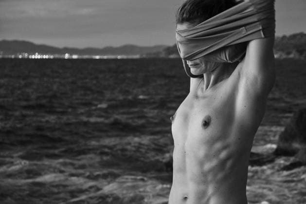 Woman taking off sweater near sea Copyright: xJeroxForradellasx Model Released