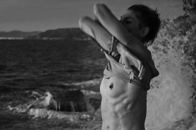 Woman taking off sweater near sea Copyright: xJeroxForradellasx Model Released