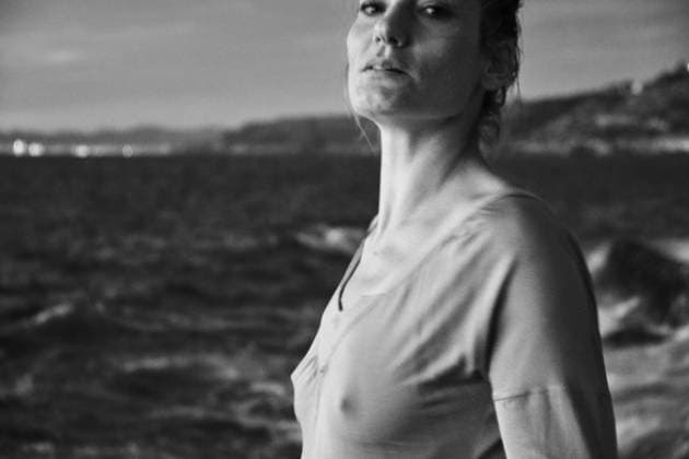 Woman taking off sweater near sea Copyright: xJeroxForradellasx Model Released