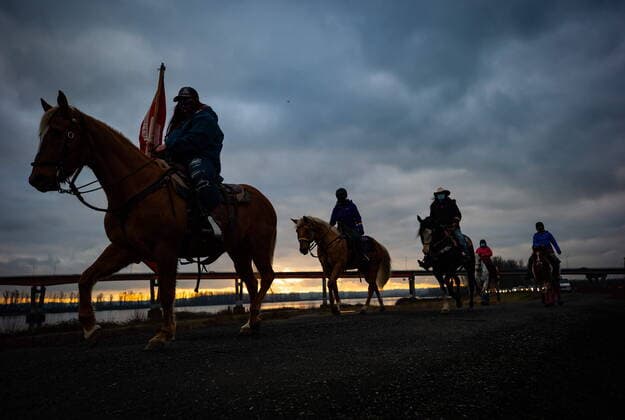 January 17, 2021, Mission, BC, Canada: People on horseback are silhouetted while leading an anti-bullying parade of more than 1,000 vehicles in support of a transgender teenager who was allegedly assaulted outside a school, in Mission, B.C., on Sunday, January 17, 2021. According to RCMP two students were arrested and charges were recommended in regards to the incident that was recorded and posted online. Mission Canada - ZUMAc35_ 20210117_zaf_c35_041 Copyright: xDarrylxDyckx