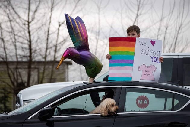 January 17, 2021, Mission, BC, Canada: A child standing through the sunroof of a vehicle holds a sign as motorists wait to participate in an anti-bullying parade of more than 1,000 vehicles in support of a transgender teenager who was allegedly assaulted outside a school, in Mission, B.C., on Sunday, January 17, 2021. According to RCMP two students were arrested and charges were recommended in regards to the incident that was recorded and posted online. Mission Canada - ZUMAc35_ 20210117_zaf_c35_053 Copyright: xDarrylxDyckx