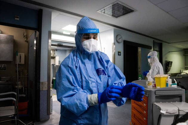 January 23, 2021, Porto, Portugal: A health worker wearing a protective suit removes gloves in a ward at the University Hospital of Sao Joao do Porto..The University Hospital of Sao Joao do Porto, a central hospital in the northern region, receives patients with Covid-19. Portugal currently has 609,136 confirmed cases, 441,556 recoveries and 9,920 death, making it the worst country in the world with the most new cases per million inhabitants. Porto Portugal - ZUMAs197 20210123_zaa_s197_234 Copyright: xRitaxFranÃAx