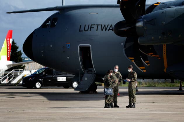 (210203) -- LISBON, Feb. 3, 2021 -- German army medical experts talk beside a military transport plane of the German Air Force after they arrived at Figo Maduro military airbase in Lisbon, Portugal, on Feb. 3, 2021. Based on a bilateral agreement, a team of German army medical experts arrived in Portugal on Wednesday to assist the country in its fight against the COVID-19 pandemic. (Photo by Xinhua) PORTUGAL-LISBON-COVID-19-GERMANY-ARMY MEDICS-ARRIVING PedroxFiuza