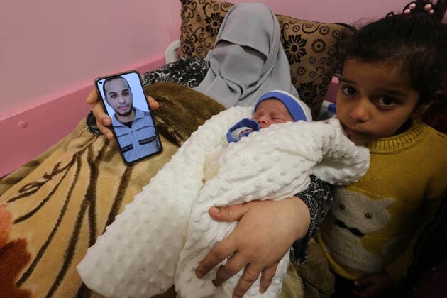 February 18, 2021, khan Younis, Gaza Strip, Palestinian Territory: The wife of the Palestinian prisoner Mohammad al-Qudra, holds her newborn baby, from whom she conceived with sperm smuggled out of an Israeli prison, at Nasser Medical Complex in khan Younis in the southern of Gaza strip on February 18, 2021. Since 2004, Palestinian security prisoners, who are denied conjugal visitations by their wives, have tried to smuggle their sperm out of Israeli prisons, so that their wives can be inseminated in fertility clinics in the West Bank and Ghazza, and bear them children khan Younis Palestinian Territory - ZUMAap3_ 20210218_zaf_ap3_173 Copyright: xAshrafxAmrax